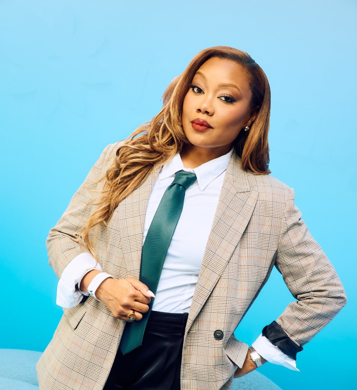 Portrait of Monica Bowie in a plaid blazer, white shirt and green tie